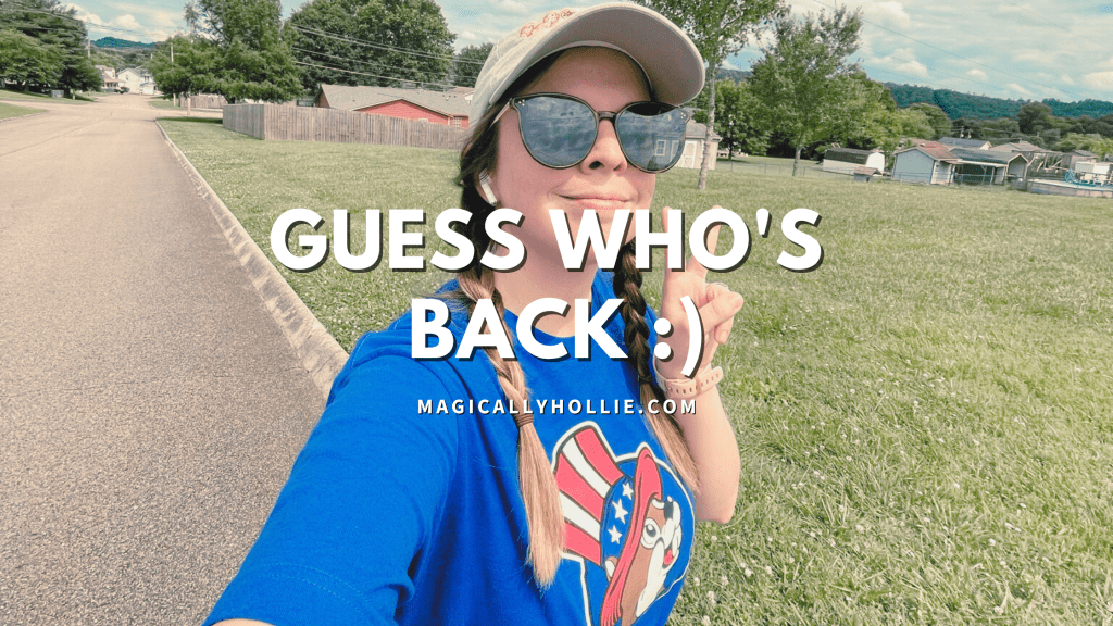 image is of a girl (me) in a blue 4th of july themed buc-ee's t-shirt, big sunglasses, and a tan hat. i have braids in my hair and am throwing up a peace sign. my smile is mid because i'm on a run and feeling very tired. i am in a neighborhood with a street, grass, and houses in the background. the image reads "guess who's back" because i am making a back to blogging post. the image also features my website name magicallyhollie.com so help drive people here.